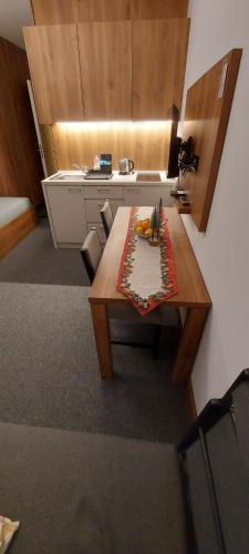 a kitchen with a wooden table and a counter at PAHULJA Vila Bela Reka Kopaonik Brzeće in Brzeće