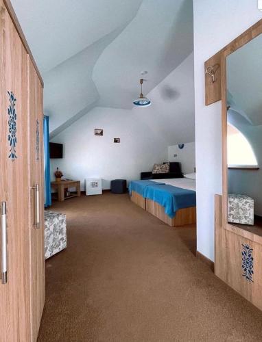 a large room with a bed and a mirror at Orizont-Mahmudia in Mahmudia