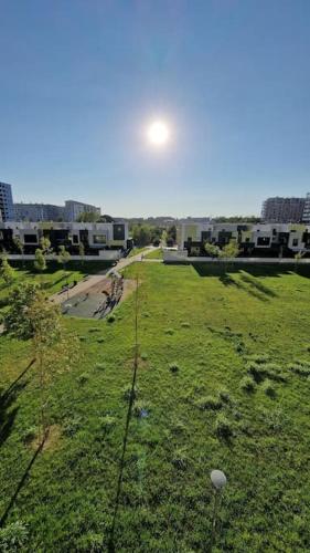 a view of a field of grass with the sun in the sky at Adriano Park View in Crescenzago