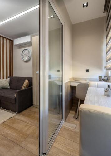 a bedroom with a sliding glass door leading to a living room at Cozy DownTown Apartment in Xanthi