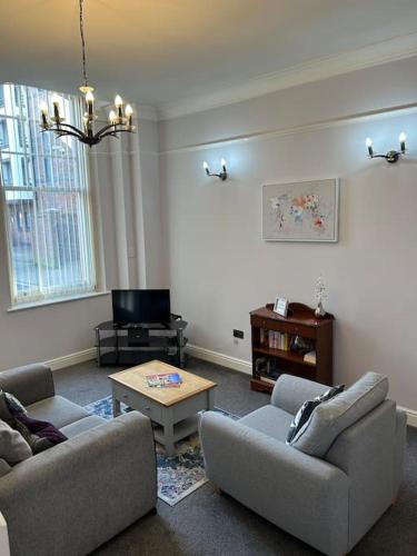 a living room with two couches and a coffee table at 10 Thurnams House in Carlisle