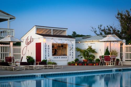a building with a swimming pool in front of a house at Sound View Greenport in Greenport