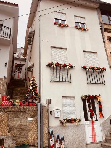 a building with a christmas tree on the side of it at VC Alojamentos T2 in Seia
