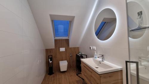 a bathroom with a sink and a mirror at Apart Bogi in Szczyglice