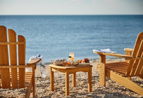 a table with a bowl of food on the beach at Sound View Greenport in Greenport