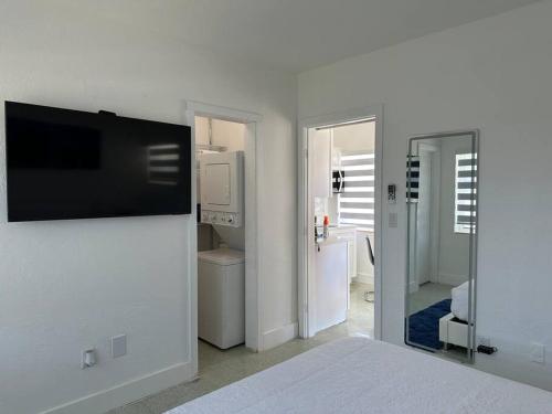 a bedroom with a flat screen tv on a wall at Villa Clara Blue-Little Havana in Miami