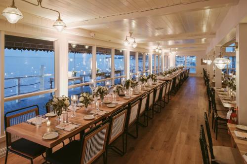 a long table in a room with windows at Sound View Greenport in Greenport