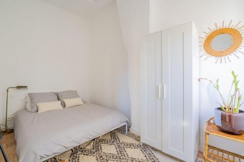 une petite chambre avec un lit et un miroir dans l'établissement Chez Ninette, le Vieux-Port à 2 minutes à pied, à Marseille