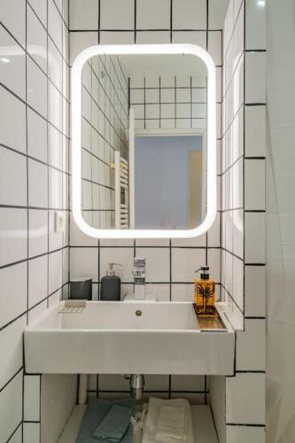une salle de bain avec un lavabo et un miroir dans l'établissement Chez Ninette, le Vieux-Port à 2 minutes à pied, à Marseille