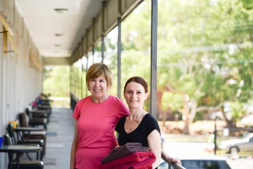 two women standing next to each other in a building at The Prince Mark Motel in Eumemmerring