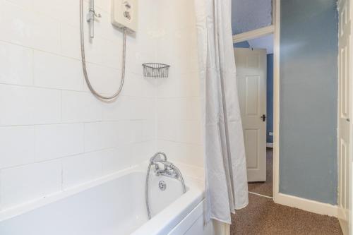 a bathroom with a shower and a bath tub at HIGH STREET APARTMENT, SLEEPS 6 GUESTs! in Bedworth