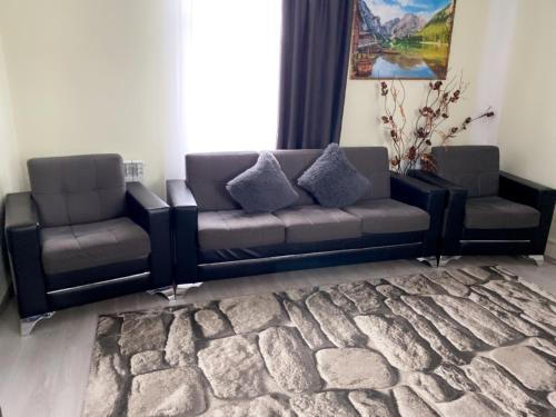 a couch and chairs in a room with a rug at Отдых в Ташире in Vorontsovka