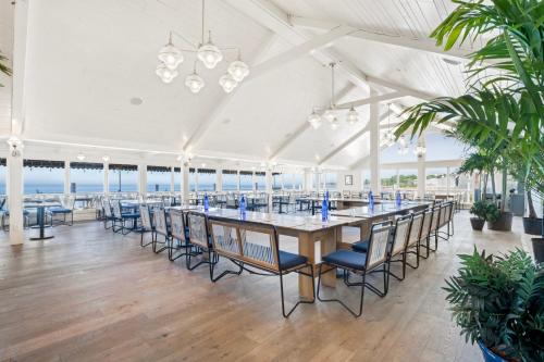 a large white room with a long table and chairs at Sound View Greenport in Greenport
