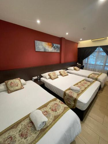 a hotel room with three beds in a room at Mizie Hotel Kuala Lumpur in Kuala Lumpur