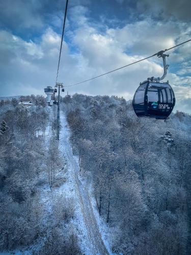 a ski lift flying over a snow covered field at Chata w Bieszczadzie apartamenty i domki z basenem Bieszczady in Polańczyk