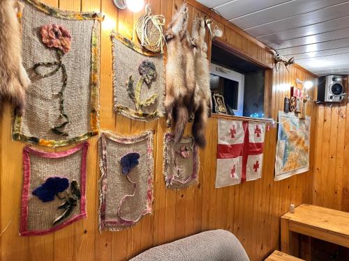 a room with a wall with a group of hanging decorations at Family Hotel Parnas 2250 in Gudauri