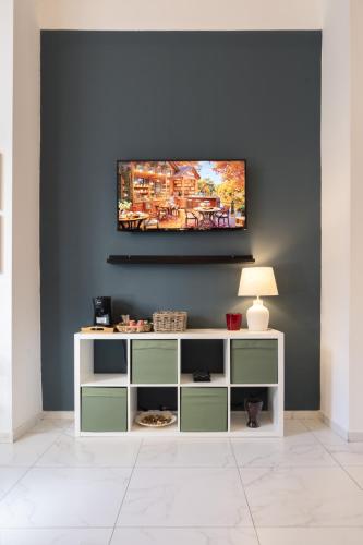 a living room with a tv on a wall at Lume Guest House in Catania