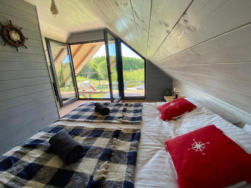 a bedroom with a large bed in a house at Mazurski Domek - Wake Up Home Ogonki in Ogonki