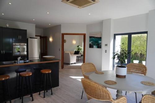 a kitchen and dining room with a table and chairs at Tuscan Villa with a View in Havelock North