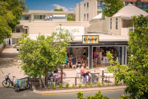 people sitting at tables outside of a restaurant at 10 Hastings Street Motel in Noosa Heads