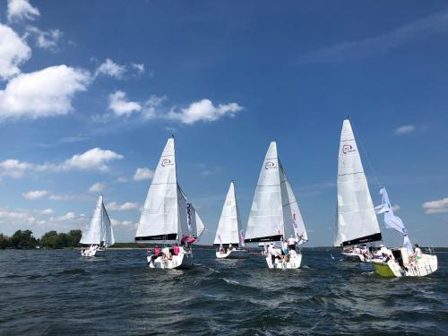 a group of small sailboats on the water at Mazurski Domek - Wake Up Home Ogonki in Ogonki
