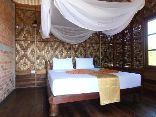 Postel nebo postele na pokoji v ubytování Ban Ban Bangalow