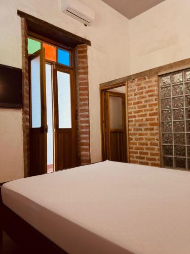 a bed in a room with a window at Casa Encanto Buga in Buga