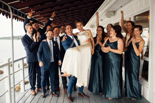 a bride and groom and their wedding party on a dock at Sound View Greenport in Greenport