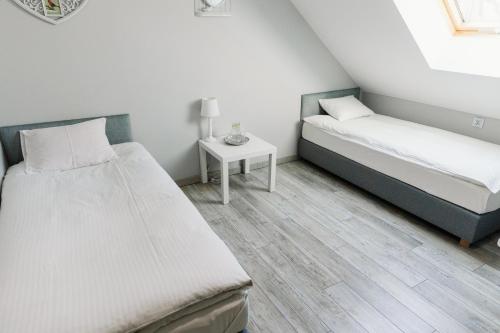 Postel nebo postele na pokoji v ubytování Agroturystyka Zagroda Borowo