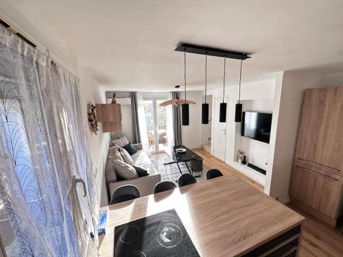 a living room with a dining table and a living room with a couch at Cosy Cottage by Alice Village Provençal Sunshine in Fuveau