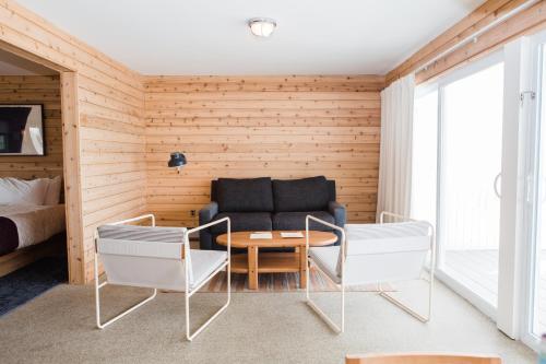 a living room with a couch and a table and chairs at Sound View Greenport in Greenport