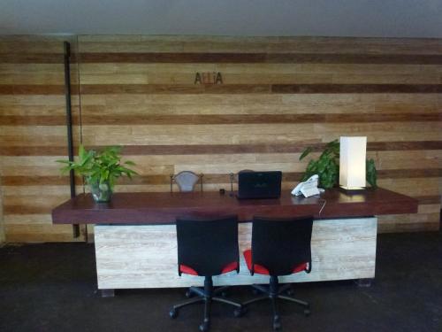 an office with a wooden desk with two chairs at Allia Residence in Nusa Dua