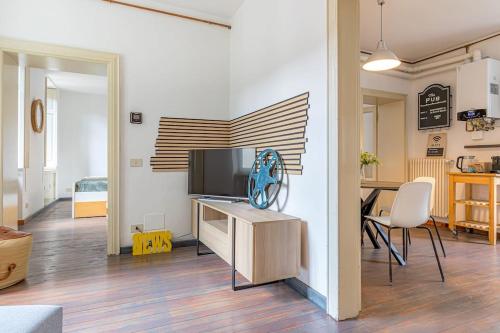 a living room with a flat screen tv on a cabinet at Ferro House in Como