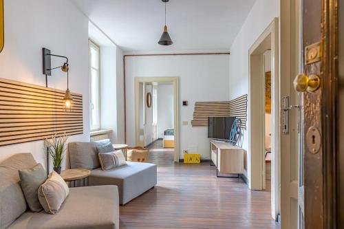a living room with a couch and a tv at Ferro House in Como