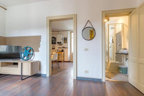 a living room with a table and a mirror at Ferro House in Como