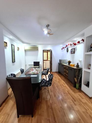 a kitchen with a table and chairs in a room at 3-Room Delta Modern Residence in Tulcea