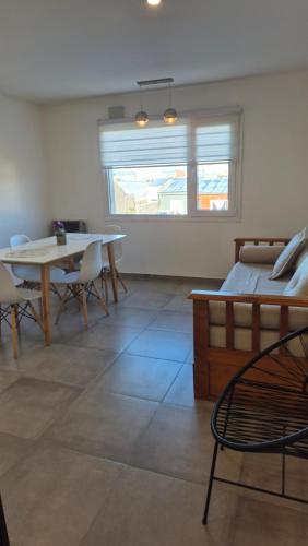 a bedroom with a bed and a table and chairs at La casona in Río Grande