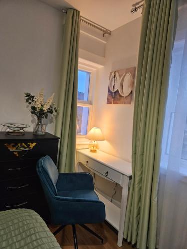 a bedroom with a desk and a blue chair at Central Chambers Suites Suite 3 in Leek