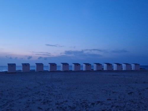 a row of containers sitting on top of a beach at Oostduinkerke View in Oostduinkerke