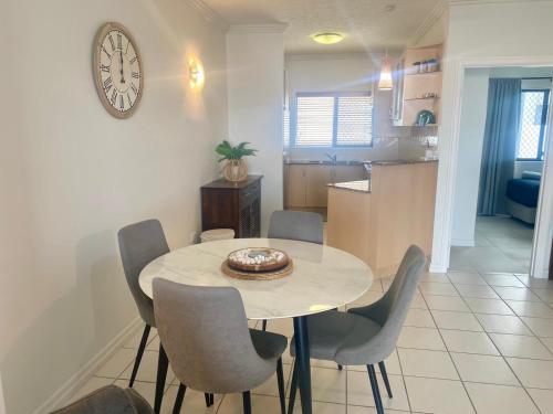a dining room and kitchen with a table and chairs at Marina Views On Melton 107-3 Melton Terrace, Townsville in Townsville