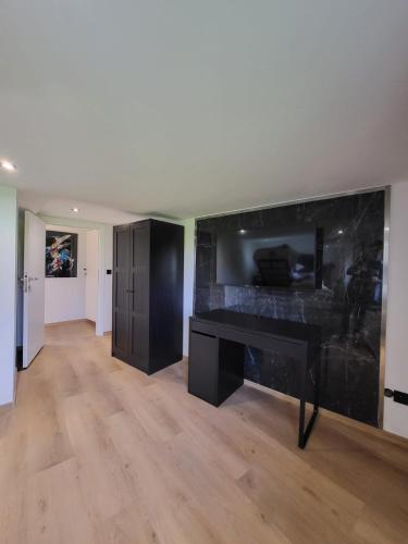 a living room with a black desk in a room at NY-GOLDEN APARTMENTS-Dortmund Airport in Dortmund