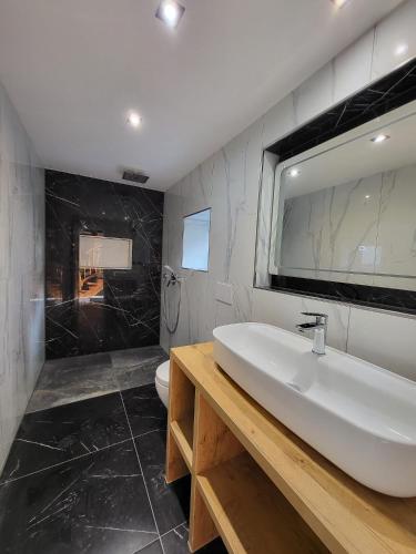 a bathroom with a white sink and a toilet at NY-GOLDEN APARTMENTS-Dortmund Airport in Dortmund