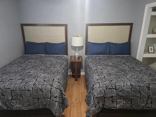 a bedroom with two beds with blue pillows at 1976HoustonGem Luminous PvTPool & HotTub DT20mins for LRG Families 6Beds 2Bath in Houston