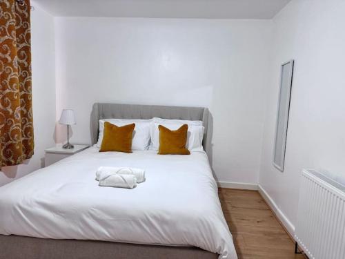 a white bed with two towels on top of it at Cosy 4-Bedroom Entire Home - Sleeps 7, Oxford in Oxford