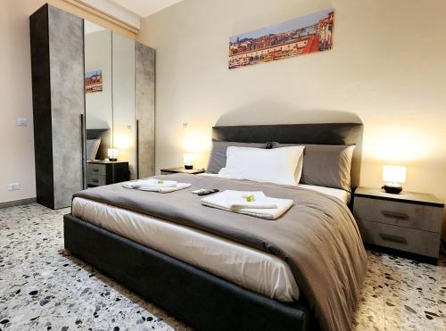 a bedroom with a large bed with two towels on it at Luna di Pisa in Pisa