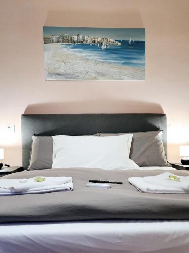 a bedroom with a bed with two towels on it at Luna di Pisa in Pisa