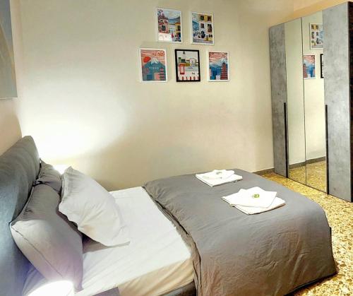 a bedroom with a bed with two towels on it at Luna di Pisa in Pisa