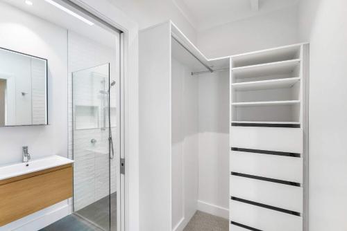 a bathroom with a shower and a sink at Luxury Central Villa with Spa Pool Prime Location in Auckland
