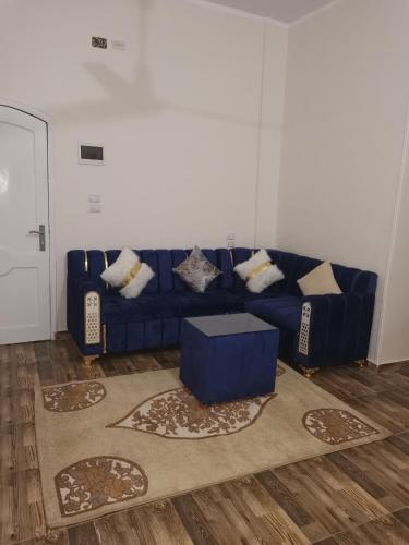 a blue couch in a living room with a rug at Hmmam in Quseir
