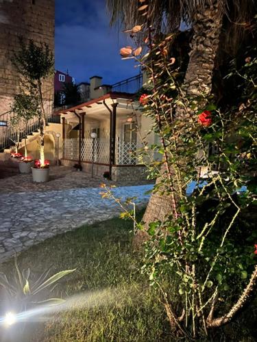 a house with a palm tree in front of a building at Villa Chianese in Naples